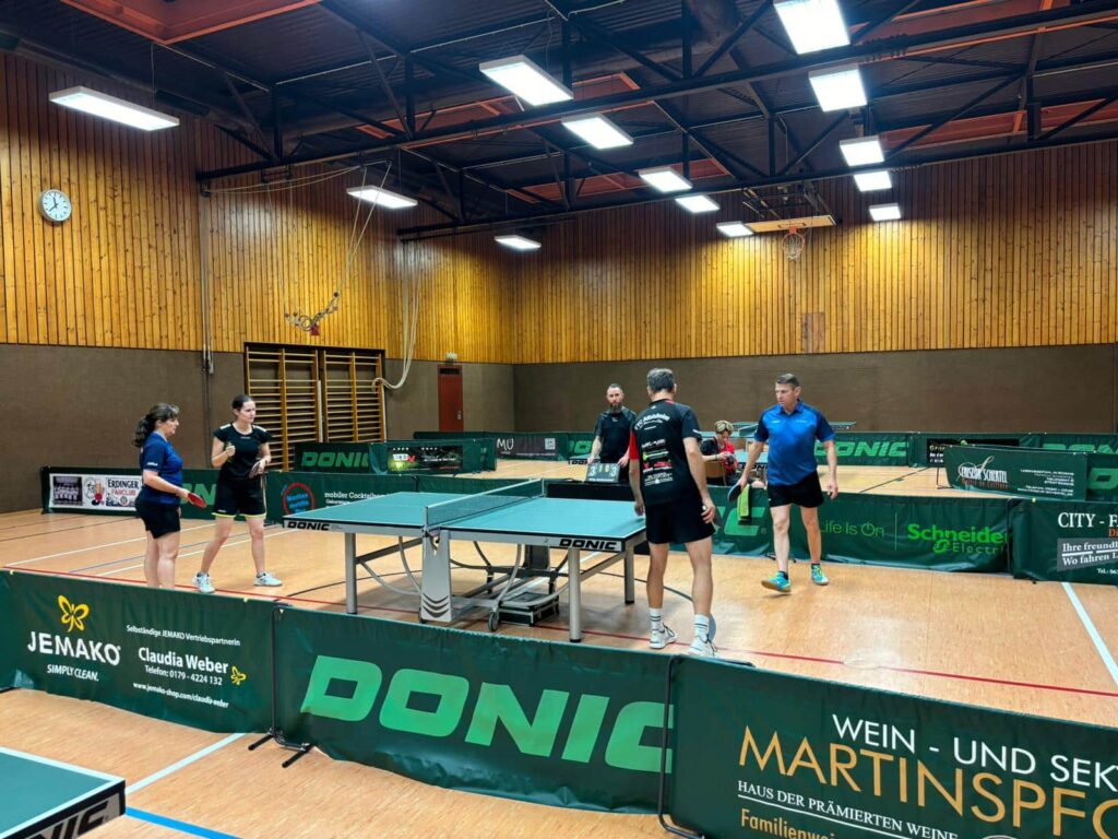 a group of people playing ping pong