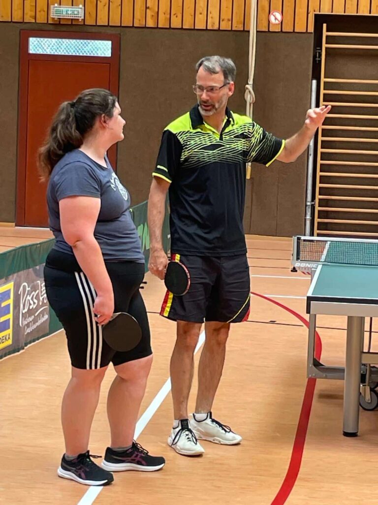a man and woman standing in a court