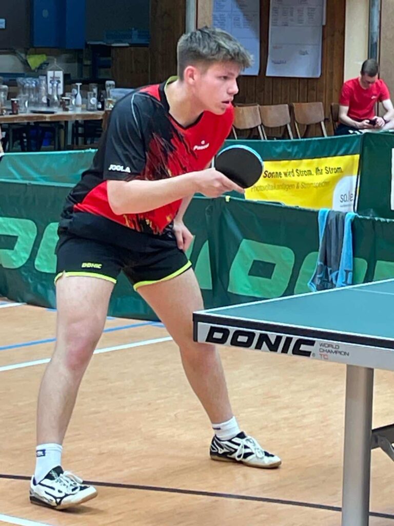 a man playing ping pong