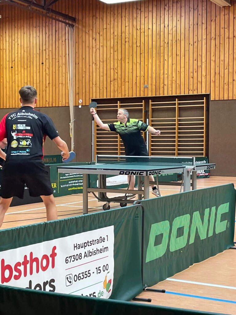 a group of men playing ping pong