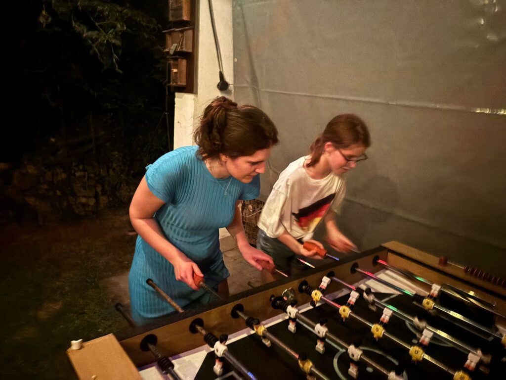 a group of people playing foosball