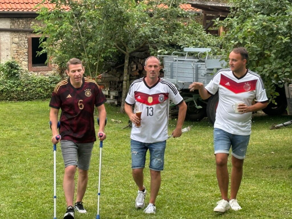 a group of men walking on grass