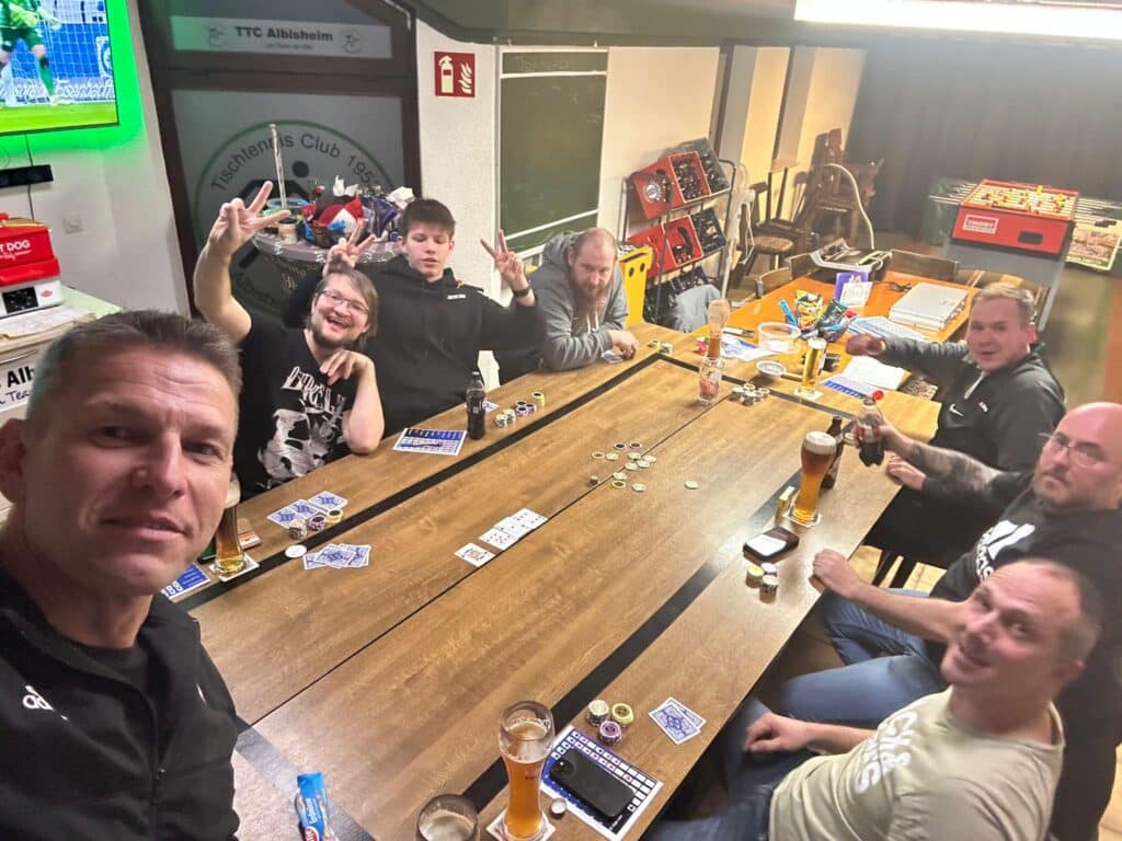 a group of men sitting around a table with drinks