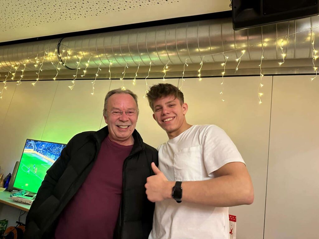 two men standing under a curtain