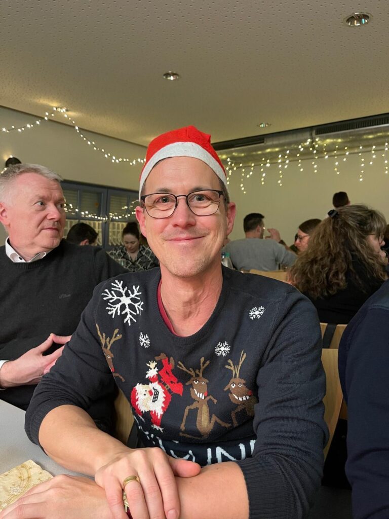 a man wearing a santa hat and glasses
