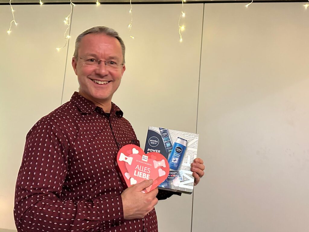 a man holding a box and a heart shaped box