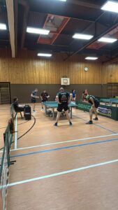 a group of people playing ping pong
