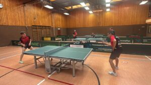 a group of people playing ping pong
