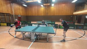a group of men playing ping pong