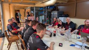 a group of people sitting around a table