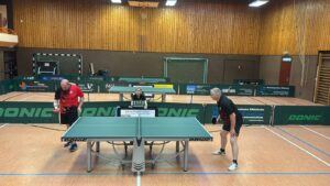a group of people playing ping pong